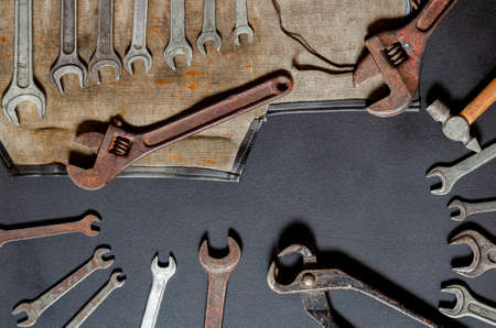 Vintage old tools on stone backdrop. Top view with copy space. Flat lay. Old rusty tools closeup. Old tools in the workshop.の写真素材