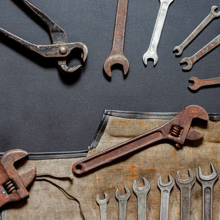 Vintage old tools on stone backdrop. Top view with copy space. Flat lay. Old rusty tools closeup. Old tools in the workshop.の写真素材
