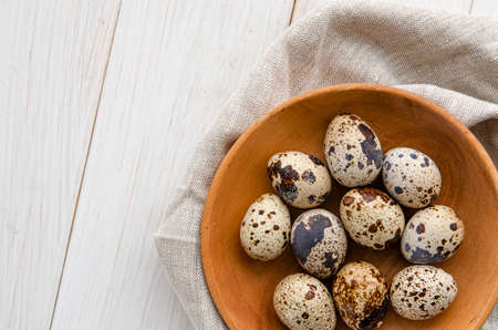 quail eggs in wooden plate over dark old wooden background. Concept of healthy eatingの写真素材