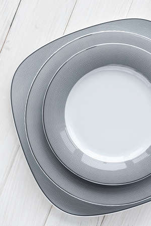 A classic set of porcelain plates of different shapes and sizes. For home and restaurantの写真素材