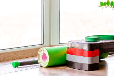 Set of fitness inventory on floor near window. Space for textの写真素材