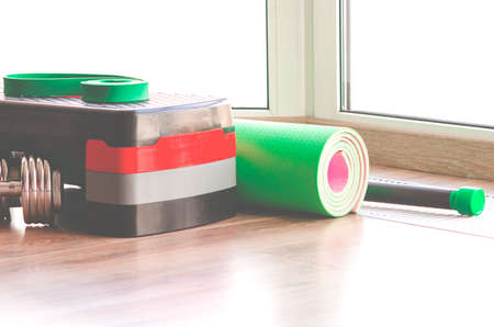 Set of fitness inventory on floor near window. Space for textの写真素材
