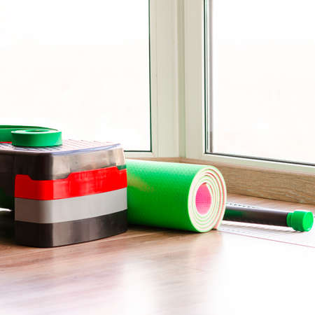 Set of fitness inventory on floor near window. Space for textの写真素材