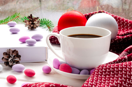 White cup of morning coffee on red warm scarf background. Cozy home autumn concept. Aesthetics blog lifestyle. Still life concept. Cappuccino or latte hot drink. Top view flat layの写真素材