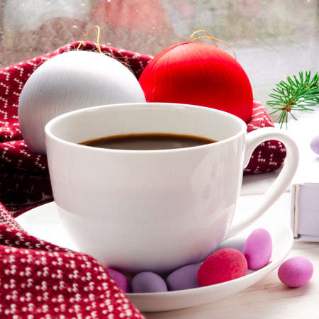 White cup of morning coffee on red warm scarf background. Cozy home autumn concept. Aesthetics blog lifestyle. Still life concept. Cappuccino or latte hot drink. Top view flat layの写真素材