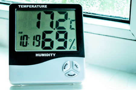Measurement of temperature and humidity in the room. Plastic windows. Condensateの写真素材
