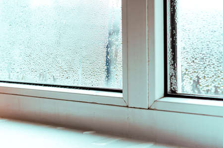 Drops of condensate and black mold on a white plastic window. Close-upの写真素材