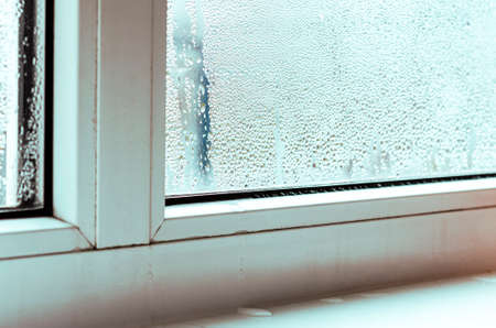 Drops of condensate and black mold on a white plastic window. Close-upの写真素材