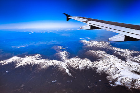 Looking through window aircraft during flight in wing with a nice blue sky. travelの写真素材