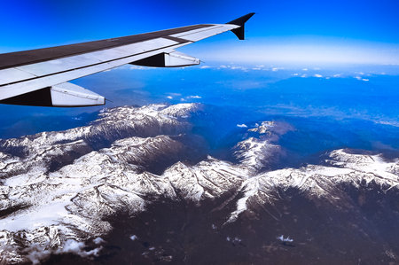 Looking through window aircraft during flight in wing with a nice blue sky. travelの写真素材