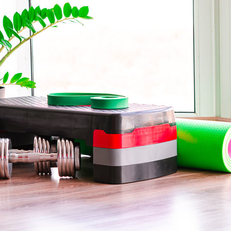 Sports concept. Sports equipment. Fitness kit on the floor against the windowの写真素材