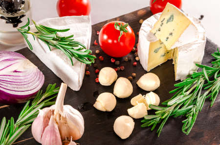 Tomatoes with mozzarella , basil and rosemary. Close-up shoot.の写真素材