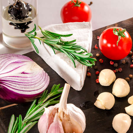 Tomatoes with mozzarella , basil and rosemary. Close-up shoot.の写真素材