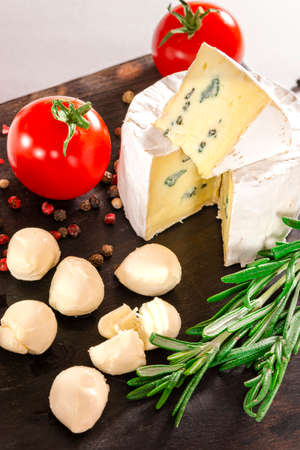 Tomatoes with mozzarella , basil and rosemary. Close-up shoot.の写真素材