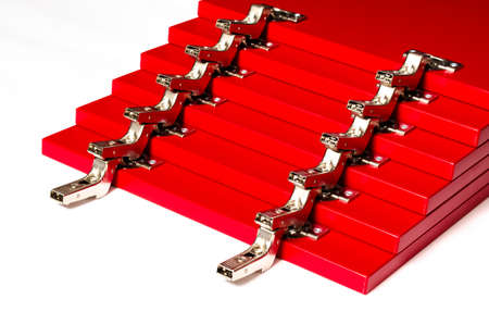 Red fronts for a chest of drawers with metal hinges lie on a white background. Assembly and installation of furniture. Businessの写真素材