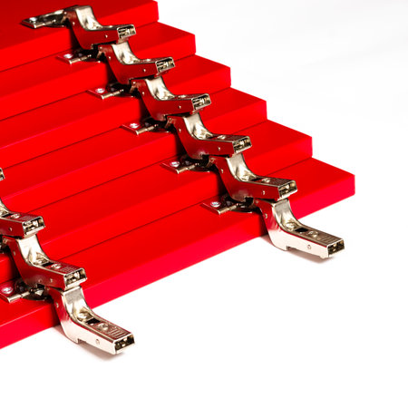 Red fronts for a chest of drawers with metal hinges lie on a white background. Assembly and installation of furniture. Businessの写真素材