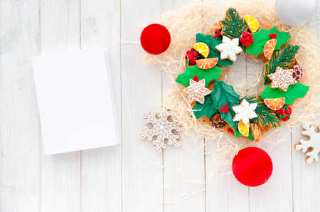 Christmas Concept. A gingerbread in the shape of a Christmas wreath lies on a wooden background. Christmas card with space for text. Decorative composition of a Christmas wreath, gingerbread cookiesの写真素材