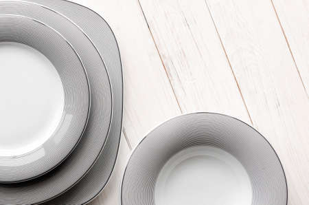 A classic set of porcelain plates of different shapes and sizes. For home and restaurantの写真素材