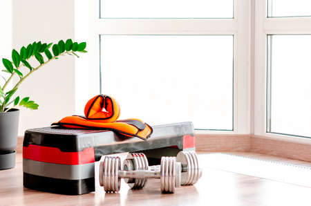 sports concept. sport equipment. Set of sports equipment for fitness classes on the floor against the windowの写真素材