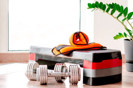 sports concept. sport equipment. Set of sports equipment for fitness classes on the floor against the windowの写真素材