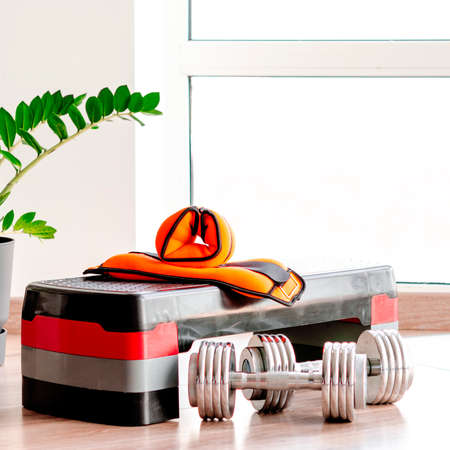 sports concept. sport equipment. Set of sports equipment for fitness classes on the floor against the windowの写真素材