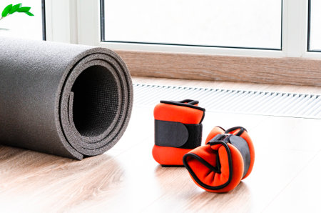 Sports concept for sports at home. Fitness mat, weights for arms and legs, harness for fitnessの写真素材