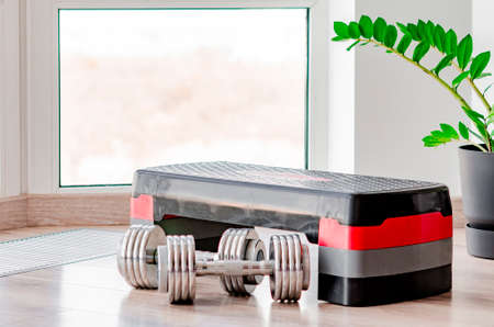 sports concept. sport equipment. Set of sports equipment for fitness classes on the floor against the windowの写真素材