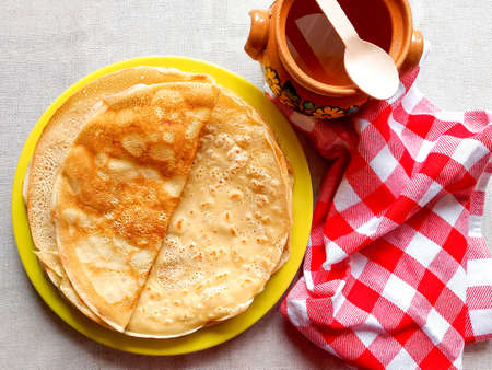 Ruddy round pancakes with honey on a plate. Homemade cakesの写真素材
