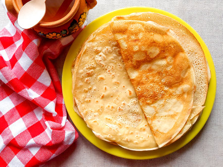 Ruddy round pancakes with honey on a plate. Homemade cakesの写真素材