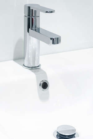 Mixer cold hot water. modern bathroom faucet. Kitchen tap. Isolated white background. Chrome plated metal.の写真素材