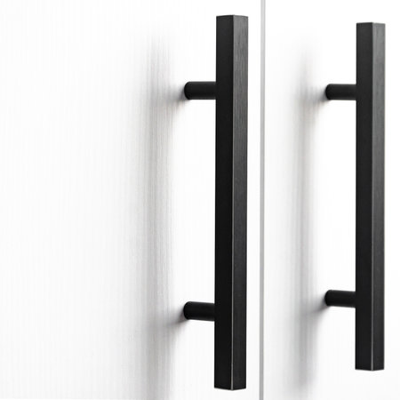 white wood cupboard door by black handle. Modern kitchen furniture concept. Cozy apartment details. Closet usageの写真素材