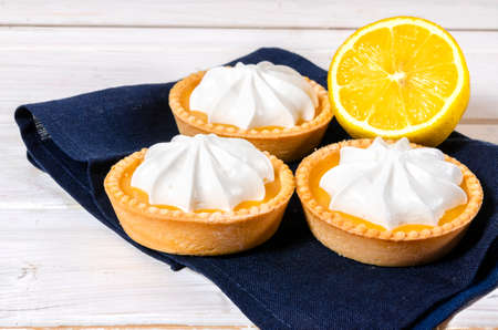 Cheesecake lemon tart cake or pie, with fresh lemon and mint. White background, lifestyle healthy sweet foodの写真素材