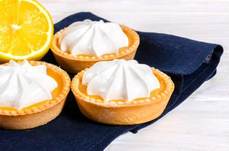 Cheesecake lemon tart cake or pie, with fresh lemon and mint. White background, lifestyle healthy sweet foodの写真素材