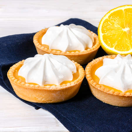 Cheesecake lemon tart cake or pie, with fresh lemon and mint. White background, lifestyle healthy sweet foodの写真素材