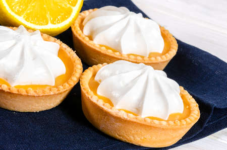 Cheesecake lemon tart cake or pie, with fresh lemon and mint. White background, lifestyle healthy sweet foodの写真素材