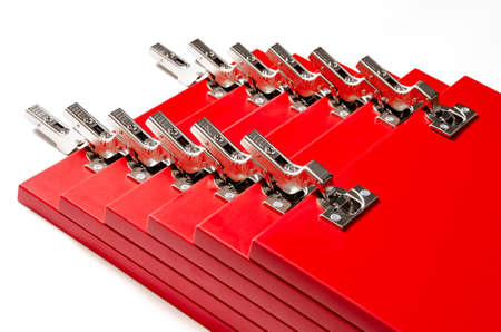 The red facades for the chest of drawers with metal loops lie on a white background. Assembly and installation of furniture. Businessの写真素材