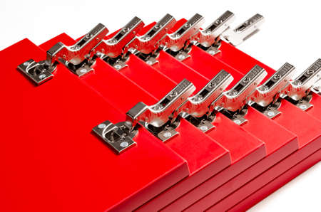 The red facades for the chest of drawers with metal loops lie on a white background. Assembly and installation of furniture. Businessの写真素材