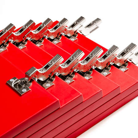 The red facades for the chest of drawers with metal loops lie on a white background. Assembly and installation of furniture. Businessの写真素材