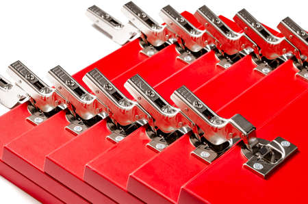 The red facades for the chest of drawers with metal loops lie on a white background. Assembly and installation of furniture. Businessの写真素材