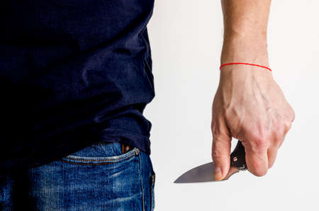 The man using folding knife. Close up folding knife in hand. EDC for men concept.の写真素材