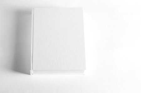 Mockup of closed blank square book at white textured paper background. wall backgroundの写真素材