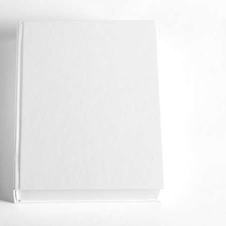 Mockup of closed blank square book at white textured paper background. wall backgroundの写真素材