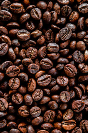 Brown grain coffee black grilled in a large number of scattered on the tableの写真素材