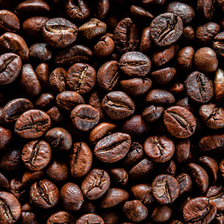Brown grain coffee black grilled in a large number of scattered on the tableの写真素材