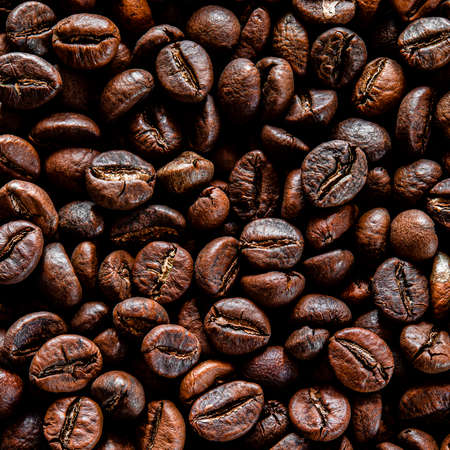 Brown grain coffee black grilled in a large number of scattered on the tableの写真素材