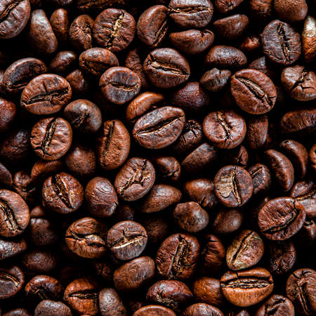 Brown grain coffee black grilled in a large number of scattered on the tableの写真素材