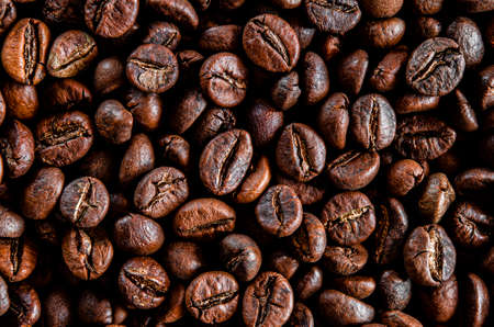 Brown grain coffee black grilled in a large number of scattered on the tableの写真素材