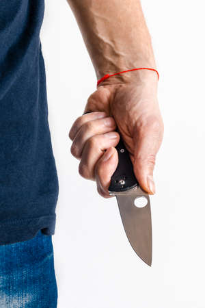 The man using folding knife. Close up folding knife in handの写真素材