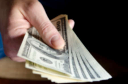 Blurred. Hands passing money under table corruption briberyの写真素材