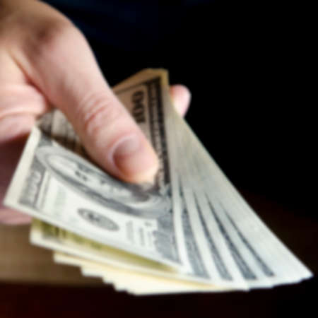 Blurred. Hands passing money under table corruption briberyの写真素材